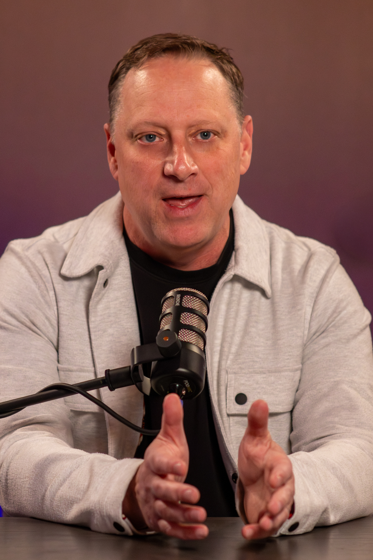 Founder speaking into a microphone during a studio content session