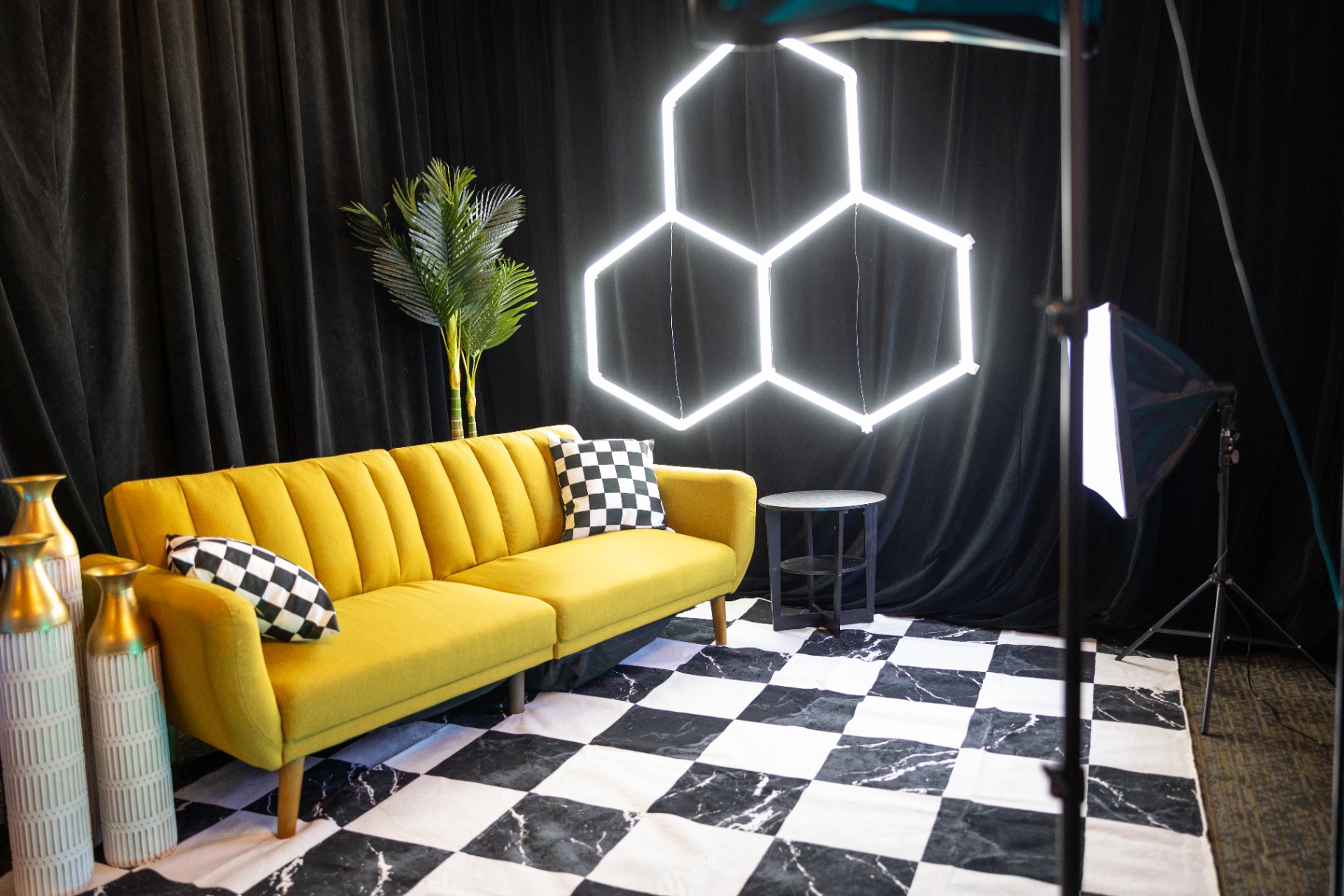 Yellow couch lounge set with hexagon neon and checker floor