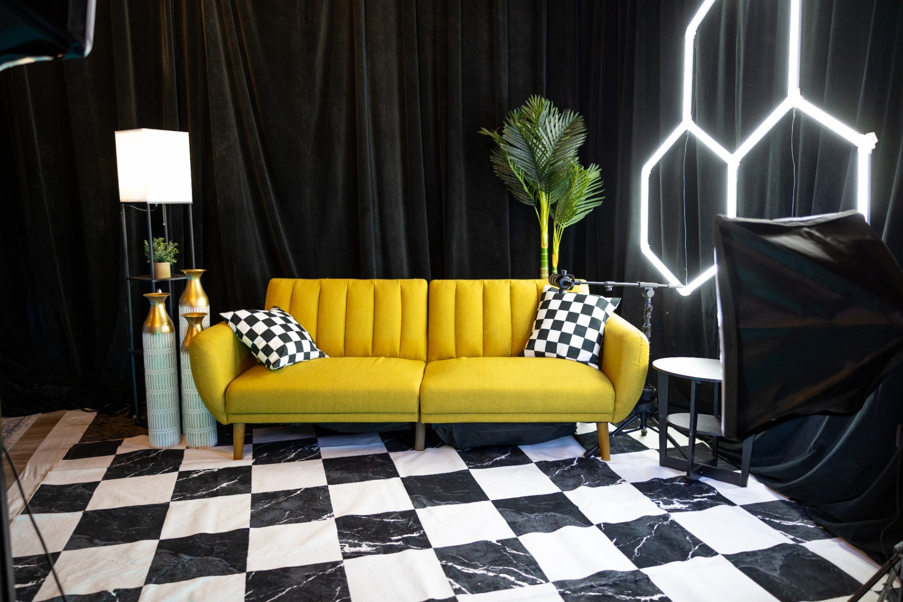 Yellow couch live selling stage with hexagon neon lighting